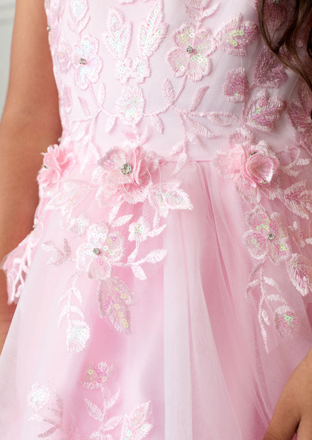 The Hope Gown in pink combines elegance with striking details. It features an illusion neckline with iridescent lace