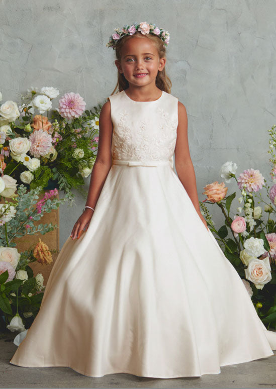 This refined toddler and girls satin gown crafted for young ladies, showcasing an ornate lace appliqué bodice paired with an elegant train embellished in delicate lace. ivory