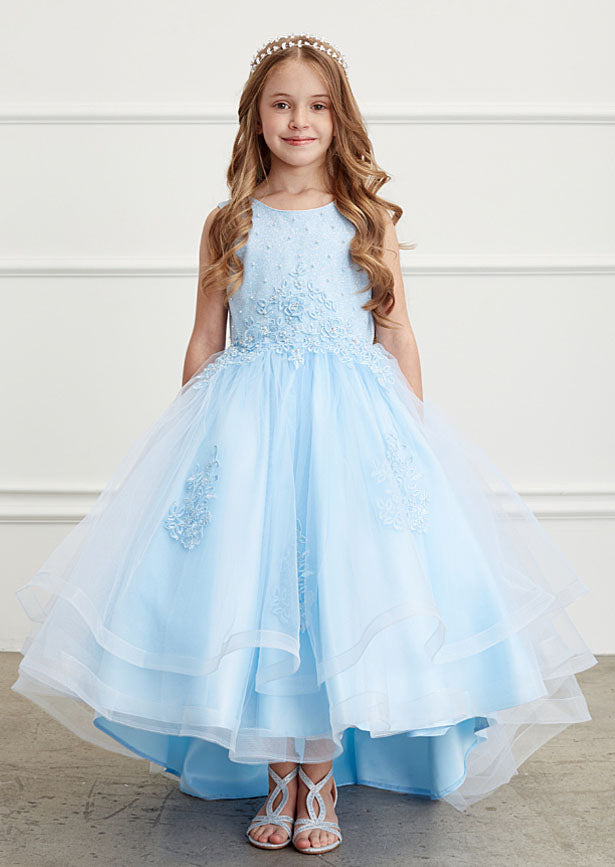 The Tabitha Dress is an elegant option for special occasions. It features a sparkling glitter bodice with lace appliqué, a layered mesh skirt with horsehair trim, and a flattering high-low hemline