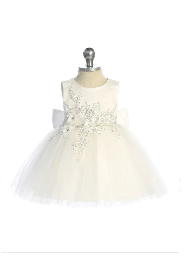 This elegant ivory girls' dress features a shimmering glitter mesh overlay adorned with dimensional floral appliqués and intricate beading
