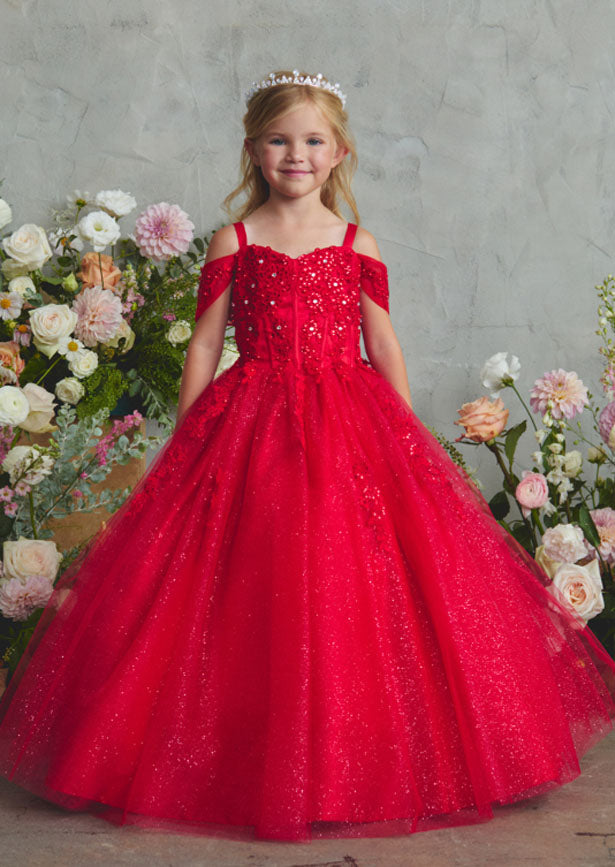 This fancy little girls red gown showcases an off-shoulder silhouette with a sweetheart neckline and intricate corded lace detailing across the bodice