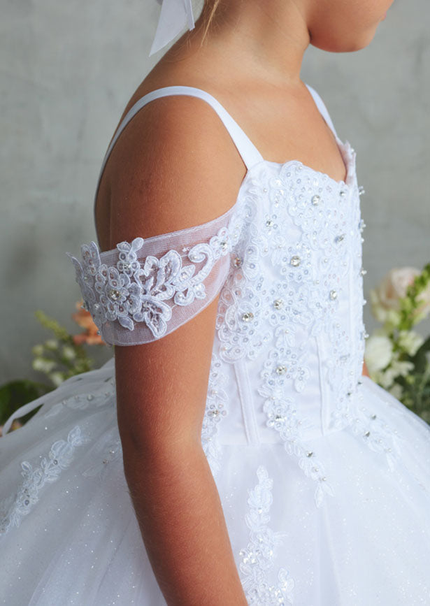 An elegant white gown featuring an off-shoulder design with a sweetheart neckline, ornate lace bodice, and voluminous glitter tulle skirt