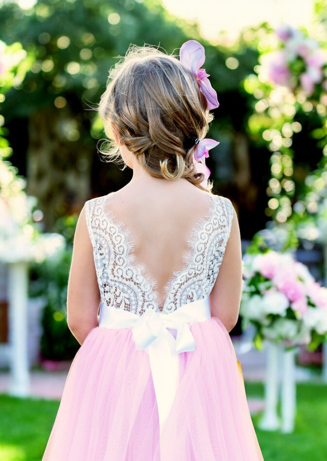 Pink sleeveless flower girl dress with lace bodice and tulle skirt