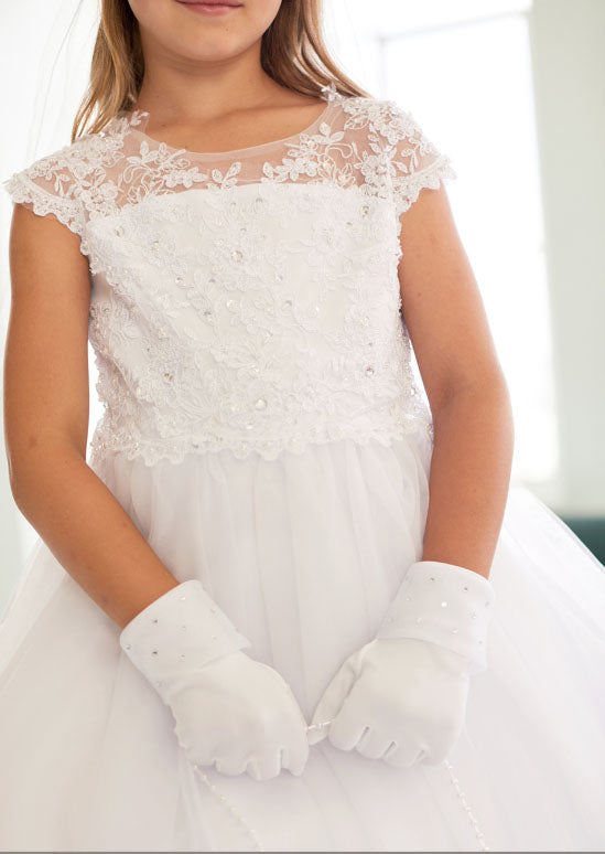 This elegant dress features a sophisticated illusion neckline adorned with delicate lace appliqué and sparkling rhinestones, creating a refined bodice perfect for flower girls and milestone celebrations