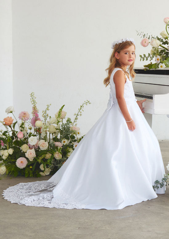 This refined toddler and girls satin gown crafted for young ladies, showcasing an ornate lace appliqué bodice paired with an elegant train embellished in delicate lace. White