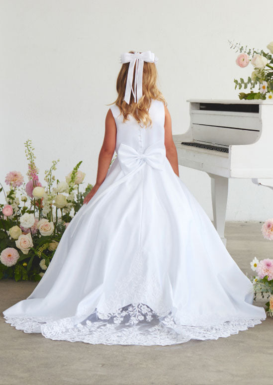 This refined toddler and girls satin gown crafted for young ladies, showcasing an ornate lace appliqué bodice paired with an elegant train embellished in delicate lace. White